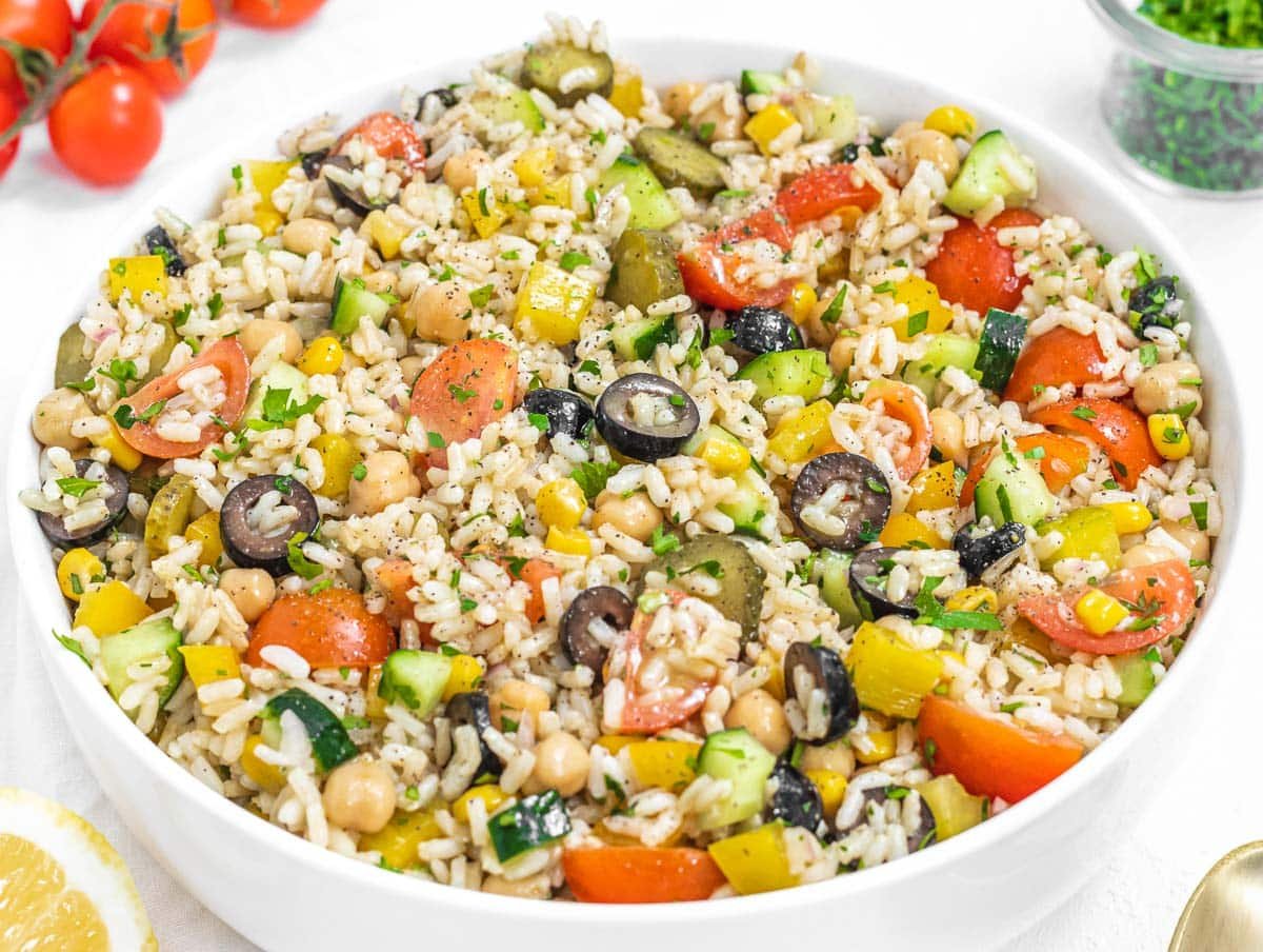 A tasty rice salad with colorful vegetables and black olives; img source: The Plant Based School