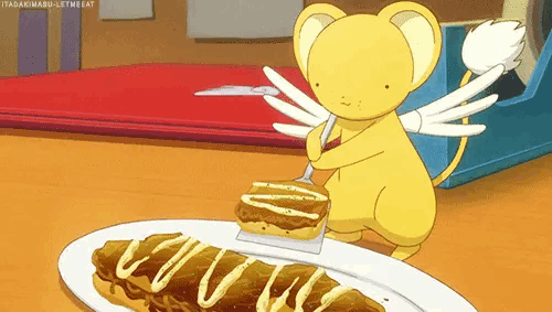 a gif of Kero from the TV show Cardcaptor Sakura eating a savory food item with a small spatula